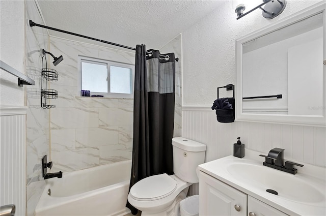 full bathroom with toilet, vanity, shower / bath combo with shower curtain, and a textured ceiling