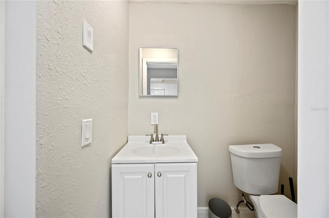 bathroom featuring toilet and vanity