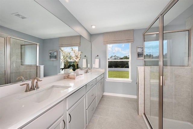 bathroom featuring vanity, tile patterned flooring, and a shower with shower door