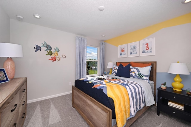 bedroom featuring a textured ceiling and carpet flooring