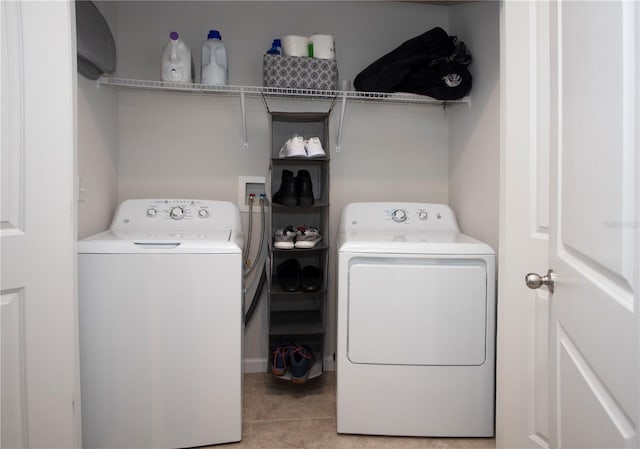 laundry room featuring separate washer and dryer and light tile patterned floors