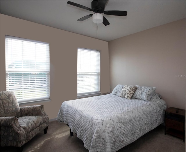 carpeted bedroom with ceiling fan and multiple windows