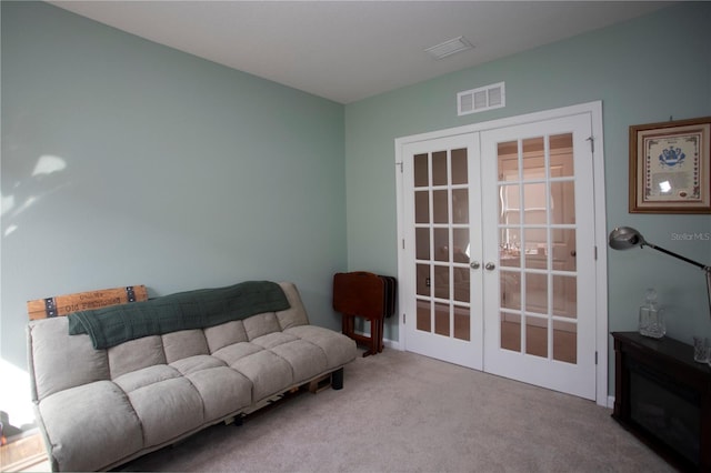 carpeted living room featuring french doors