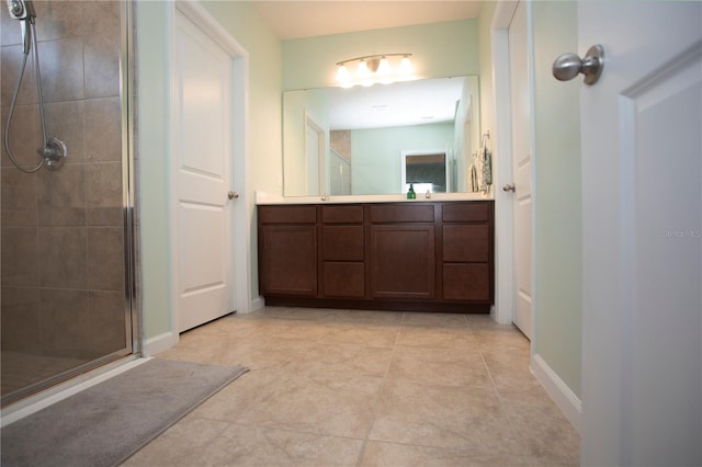 bathroom with tile patterned floors, vanity, and walk in shower