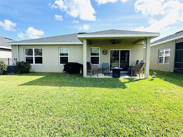 back of house with ceiling fan, a patio area, and a yard