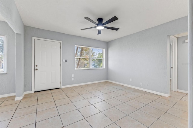 interior space featuring ceiling fan and light tile patterned floors