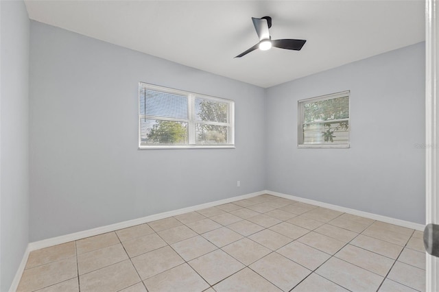 unfurnished room with ceiling fan and light tile patterned floors