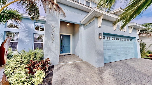 view of exterior entry with a garage