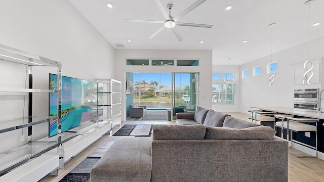 living room featuring ceiling fan and light wood-type flooring