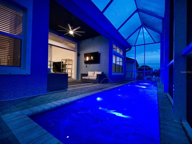 view of swimming pool with pool water feature and ceiling fan