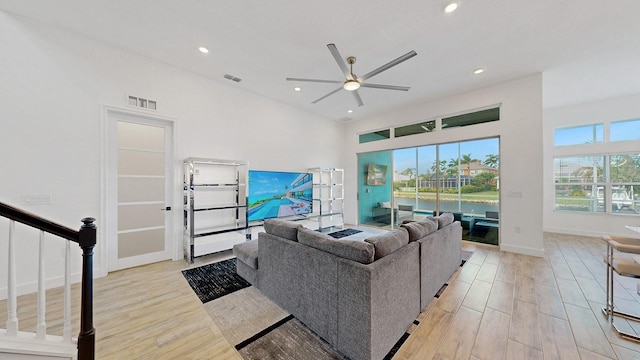 living room featuring ceiling fan and light hardwood / wood-style flooring