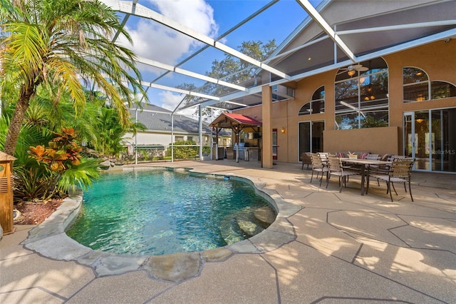 view of pool featuring a lanai, ceiling fan, and a patio area