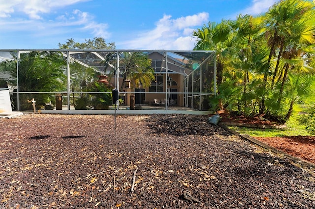 back of property with a lanai