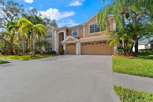 view of front of property with a garage and a front yard