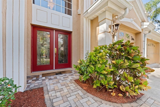 entrance to property with a garage and french doors