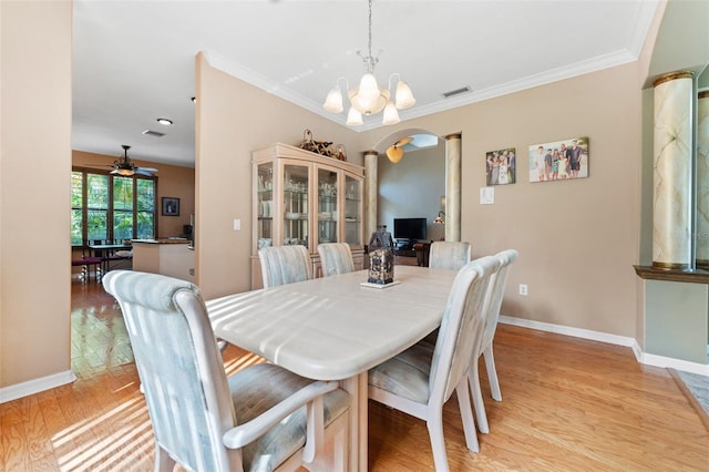 dining room with ceiling fan with notable chandelier, ornamental molding, and light hardwood / wood-style flooring