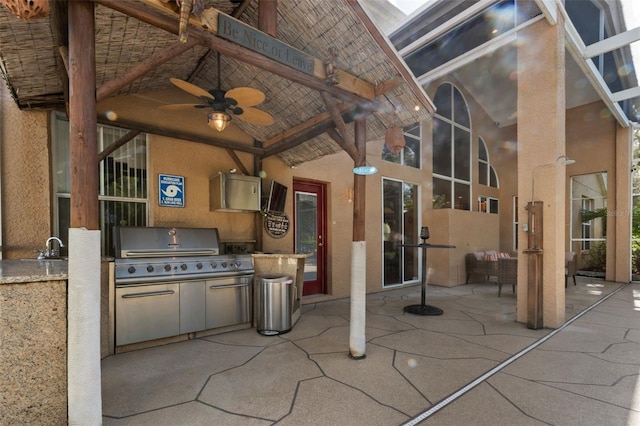 view of patio / terrace with exterior kitchen, a grill, and ceiling fan