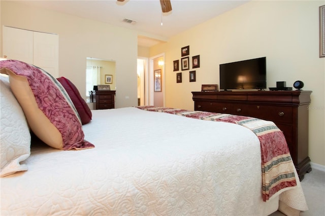 carpeted bedroom featuring a closet and ceiling fan