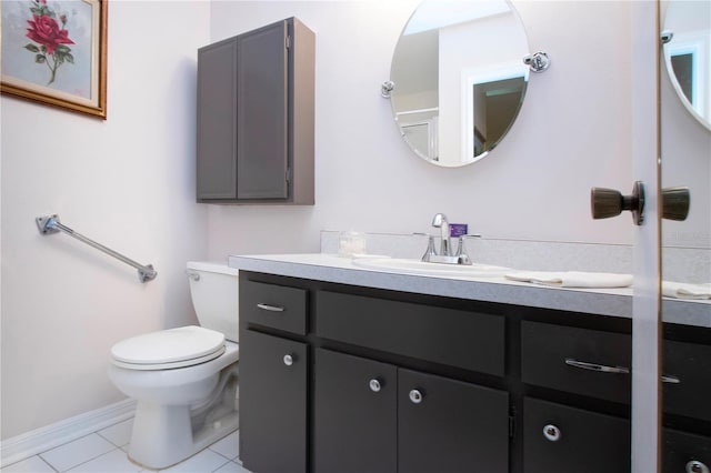 bathroom featuring toilet, vanity, and tile patterned flooring