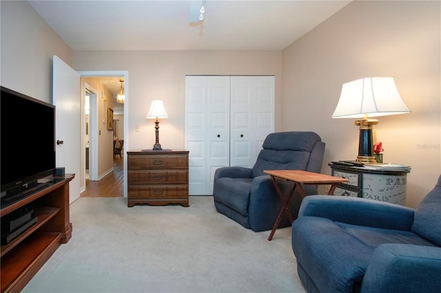 sitting room featuring light colored carpet