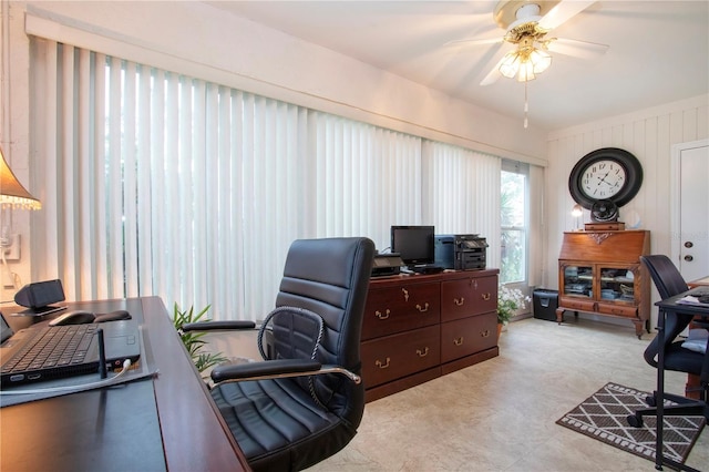 office area featuring wood walls and ceiling fan