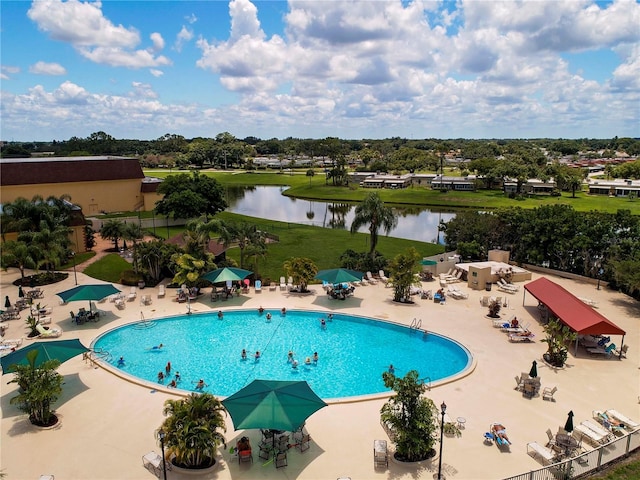 view of pool featuring a water view and a patio area