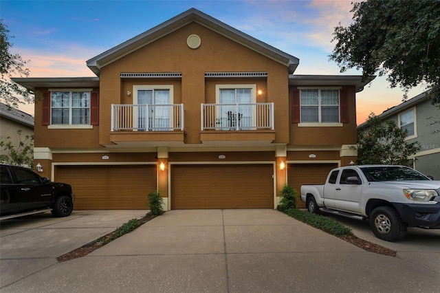 multi unit property with a balcony and a garage