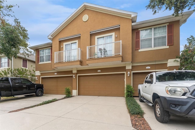 multi unit property featuring a garage and a balcony