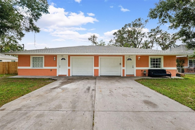 single story home featuring a garage and a front lawn