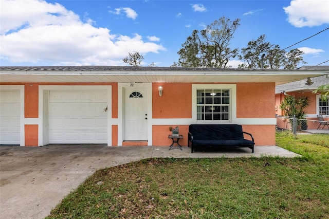 view of front of home featuring a garage and a front lawn