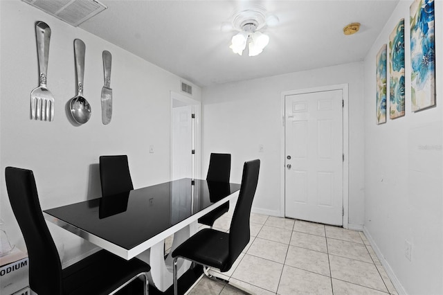 tiled dining area featuring ceiling fan