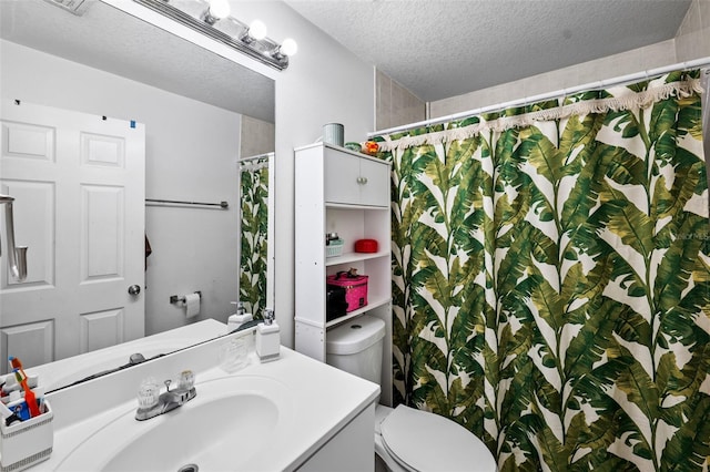 bathroom featuring vanity, a textured ceiling, toilet, and a shower with curtain