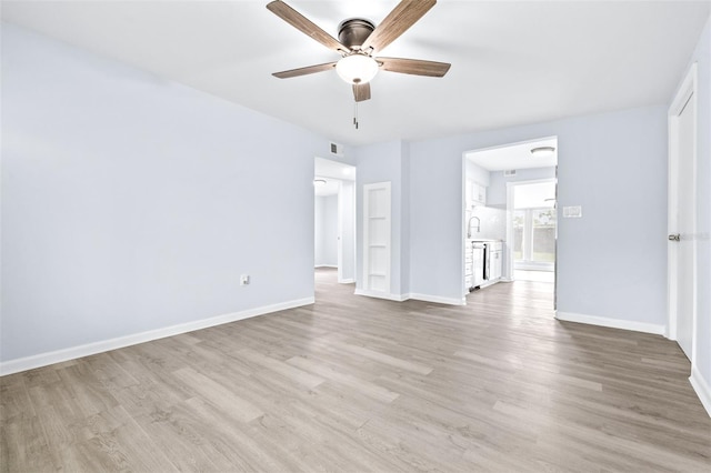 empty room featuring ceiling fan and light hardwood / wood-style flooring