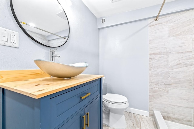 bathroom with walk in shower, vanity, and toilet