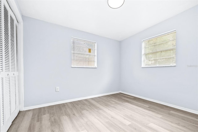 unfurnished bedroom with a closet and light hardwood / wood-style flooring