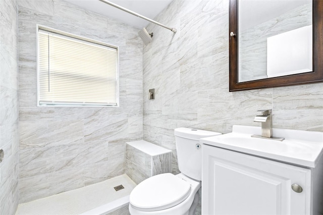 bathroom featuring toilet, vanity, tile walls, and tiled shower