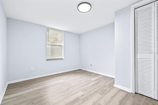 unfurnished bedroom featuring light hardwood / wood-style floors and a closet