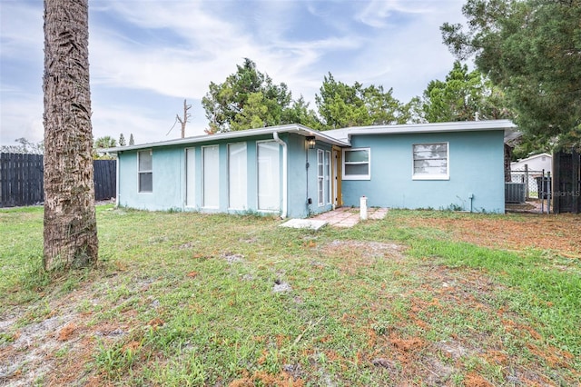 rear view of house with a yard