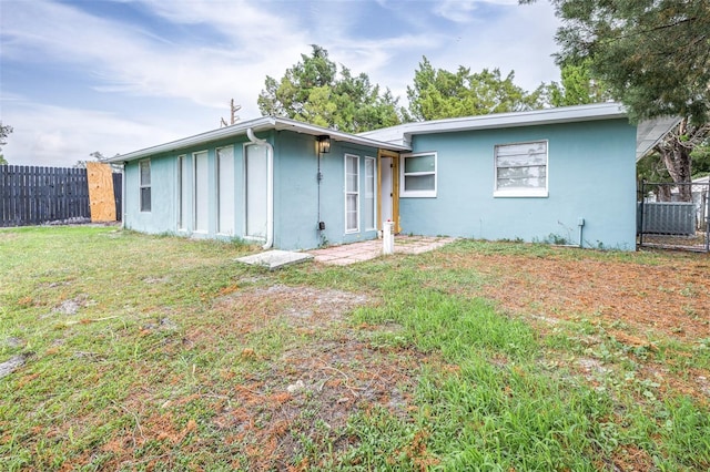 rear view of house with a yard