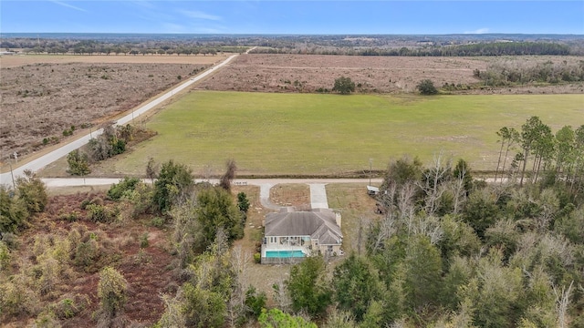 birds eye view of property with a rural view