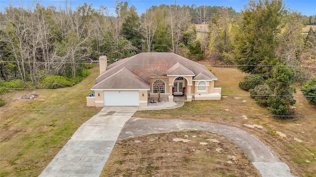 view of front facade with a front yard and a garage