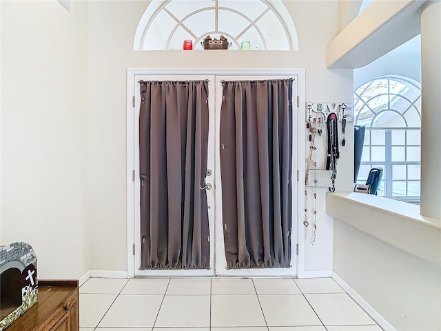 tiled entryway with a high ceiling