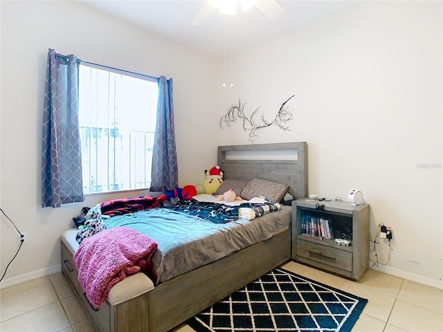 bedroom with ceiling fan and light tile patterned floors