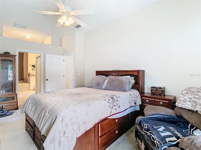 tiled bedroom featuring ceiling fan and connected bathroom