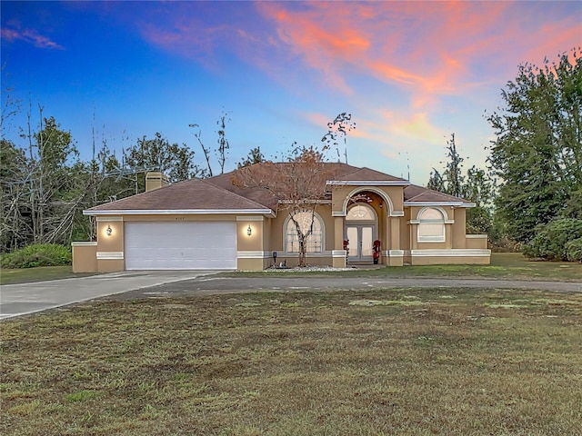 view of front of house with a lawn and a garage