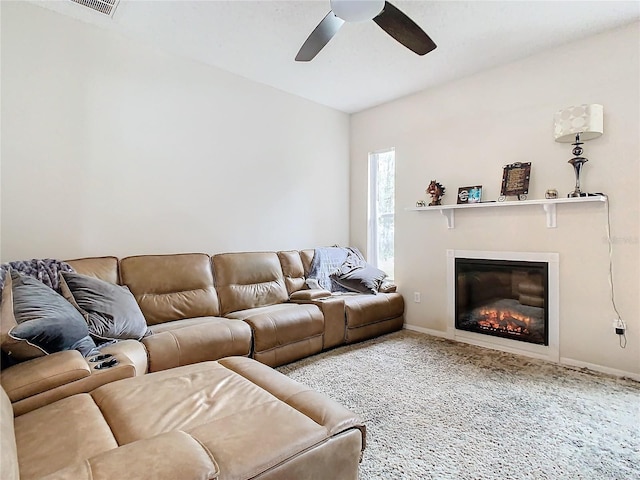 carpeted living room with ceiling fan