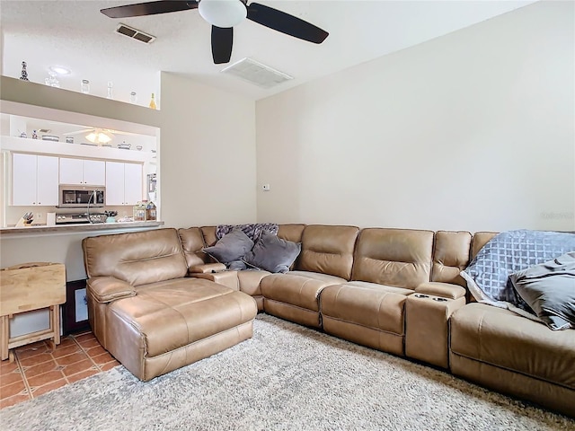 tiled living room featuring ceiling fan