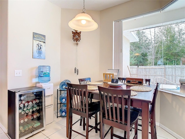 dining space featuring beverage cooler and light tile patterned flooring