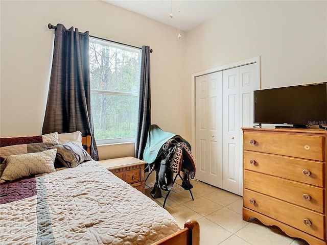 tiled bedroom with a closet