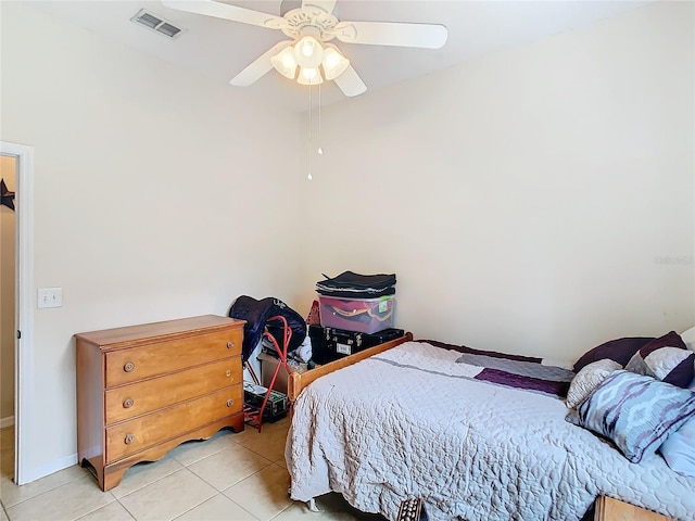 tiled bedroom featuring ceiling fan